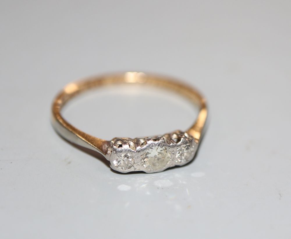 A 1930s 18ct and plat three stone diamond ring, size M, gross 1.7 grams.
